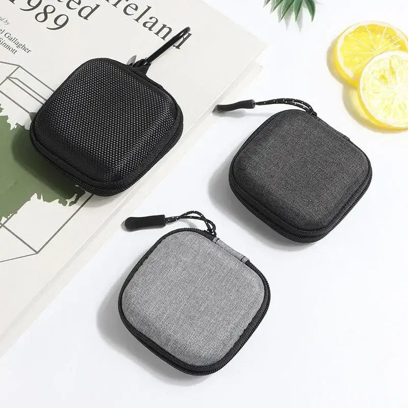 Shockproof Headphone Storage Bag featuring three compact cases ideal for organizing and protecting headphones.