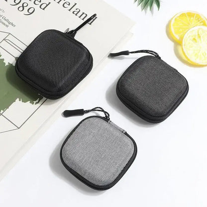 Shockproof Headphone Storage Bag featuring three compact cases ideal for organizing and protecting headphones.
